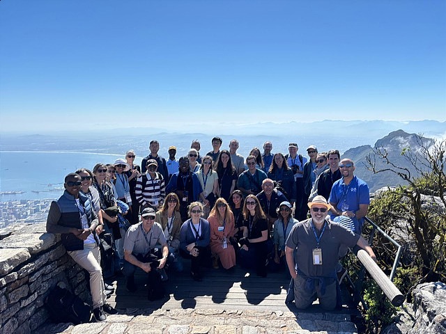 Attendees of the OBVI meeting post for a photo at a lookout above Cape Town.